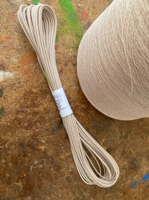 Blood Knot Camel 2254 hard-laid cordage hank beside the Camel yarn cone