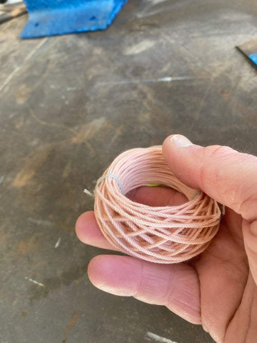 Blood Knot Coral hard-laid cordage held in hand