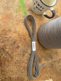 Blood Knot Mid Grey hard-laid cordage beside the Mid Grey yarn cone